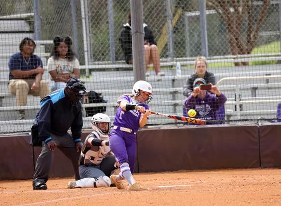 softball player batting